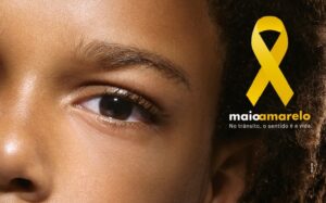 Arte com foto de uma criança negra com o texto Maio Amarelo No Trânsito, o sentido é a vida.